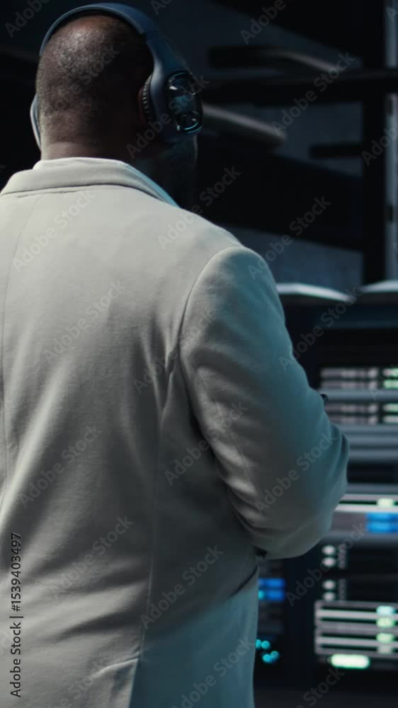 Poster vertical video software developer in data center workspace coding on tablet, analyzing metrics, opti