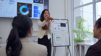 Professional businesswoman presenting detailed marketing insights to engaged colleagues during strategic team meeting in contemporary office environment - Powered by Adobe