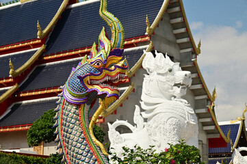 Statues of Naga and Singha, which are animals in Thai art, decorate the front of the ordination hall and chapel at Wat Den Sali Si Mueang Kaen temple. Located at Cheng Mai Province in Thailand.