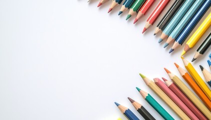 Colorful pencils arranged in a corner border on white paper
