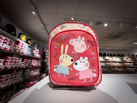 BELGRADE, SERBIA - APRIL 22, 2025: Peppa Pig themed children backpack displayed on a counter in a Belgrade retail store, Peppa pig is a British children animated series.