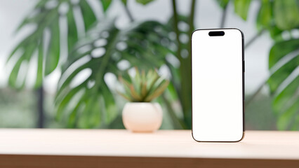 Mobile phone over wooden table desk with blank screen for mockup. Cool and natural background. Copy space, empty space background for design or text.