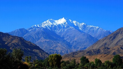 Fototapeta premium Majestic mountain range with snow-capped peak