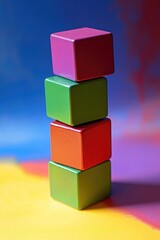 Obraz premium Colorful wooden blocks stacked vertically against a vibrant multicolored background