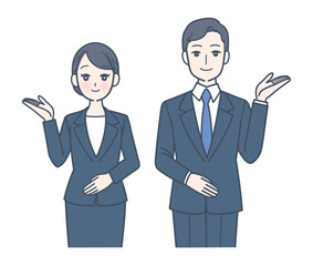 笑顔で案内するスーツ姿の男女