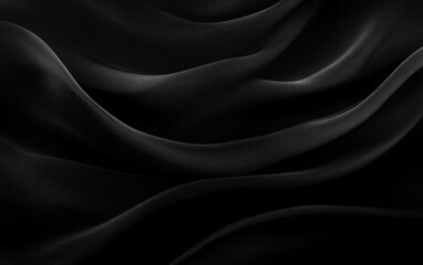 Obraz premium Close-up of smooth, flowing black fabric with soft light highlighting gentle waves and folds creating an elegant and mysterious atmosphere