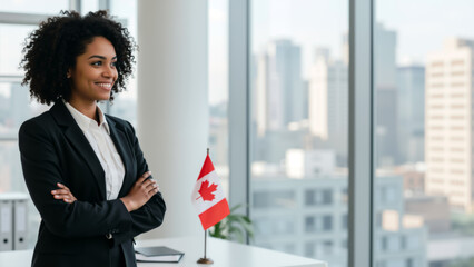 Smiling Black businesswoman in an office with a Canadian flag. Success and diversity in Canadian business.