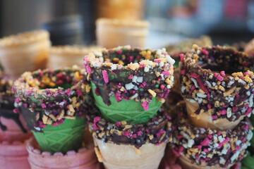 Colorful ice cream cones stacked at a dessert shop
