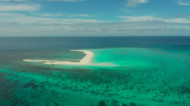Sandy white island with beach and sandy bar in the turquoise atoll water, aerial drone. Sandbar Atoll. Tropical island and coral reef. Summer and travel vacation concept, Camiguin, Philippines.