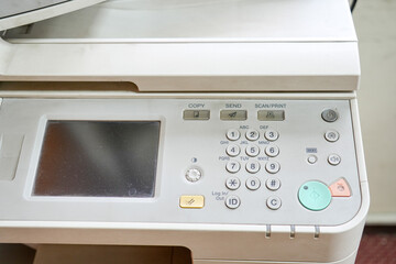 The control panel of a photocopier consisting of various number buttons, function buttons such as...