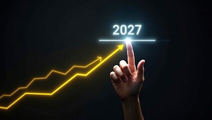Business 2027 growth concept with a hand touching a digital finance graph on a screen