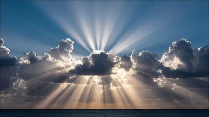 Sunlight piercing through dark clouds over the ocean.