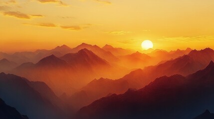 Obraz premium Golden sunset casting warm light over layered mountain ranges with mist creating a peaceful and majestic atmosphere