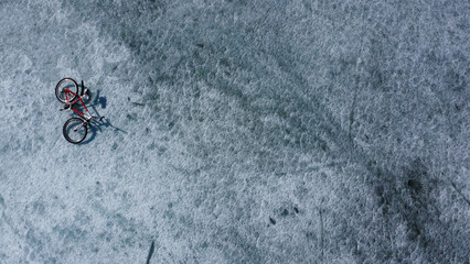 Top down view of Red bicycle on snowed ice surface