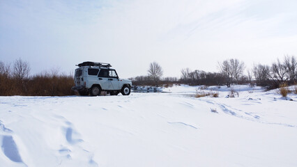 Off road vehicle on snowed countryside