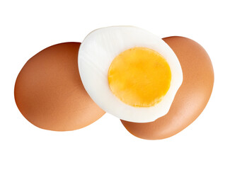 Front view of raw brown chicken eggs and cooked or boiled chicken egg with egg yolk in half in small pile isolated with clipping path in png file format