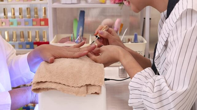 Asian senior woman happy to show beautiful fingers joyful beautify in nail and spa shop with worker female or beauty small business entrepreneur, elderly pensioner with silver hair fashion lifestyle