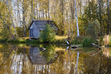 Tranquil Reflections: House and Trees Mirrored in River