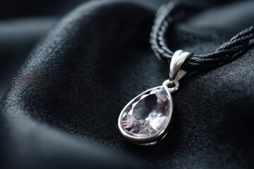 Elegant silver necklace with sparkling gemstone pendant on black velvet fabric