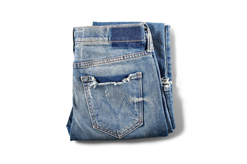 Folded Pair of Distressed Blue Denim Jeans on White Background