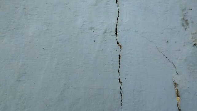the house wall is cracked. The crack was caused by extreme weather