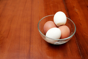 Bowl containing chicken boiled egg  on the kitchen table, prepares breakfast at home, health care and food concept. Copy space
