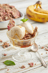 Banana nice cream scoops with caramel sauce and biscuit