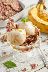 Banana nice cream scoops with caramel sauce and biscuit
