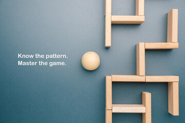 A wooden ball about to navigate a structured maze of wooden blocks, symbolizing strategic thinking,...