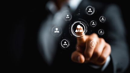 A hand in a business suit interacts with virtual icons representing people, symbolizing digital networking and human resources technology.