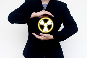 Nuclear presentation concept showing a hand holding a glowing radioactive symbol. Ideal for...