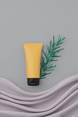 Yellow Hand Cream Tube on Gray Linen with Rosemary Sprig