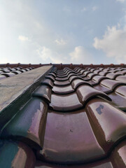 Fototapeta premium Close-up view of ceramic roof tiles under a bright blue sky