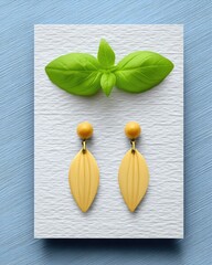 Yellow Leaf Shaped Wooden Earrings on Textured Card with Green Leaf
