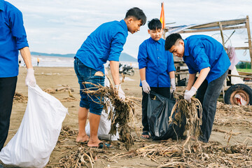 Volunteers clean up a beach in an effort to protect the environment in a coastal community