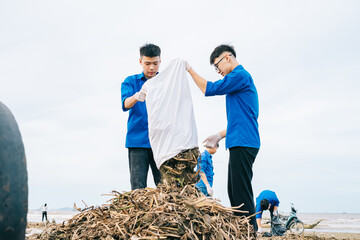 Volunteers engage in beach cleanup activity, collecting debris and plastic waste to protect marine life and promote environmental awareness in coastal area