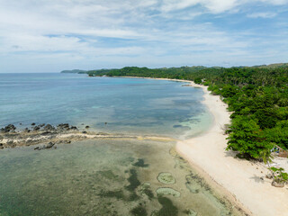 Transparent sea water and waves on white sand beach. Santa Fe, Tablas, Romblon. Philippines.
