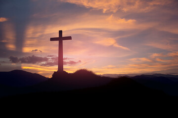 cross on blurry sunset background .	