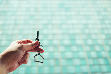 House model and key in home insurance broker agent ‘s hand or in salesman person. Real estate agent offer house, property insurance and security, affordable housing concepts