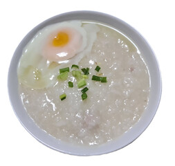 Chinese style minced pork porridge with soft boil egg and chopped spring onion on top for breakfast isolated on white background 