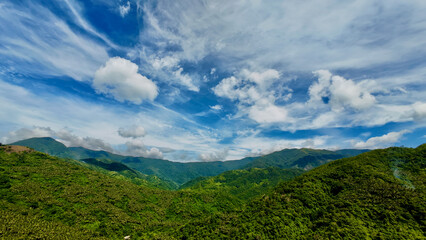 Fototapeta premium Mountain landscape with clouds. Aerial view of jungle covered mountain range and clouds over the mountains.
