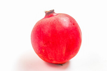 whole red pomegranate isolated on white background
