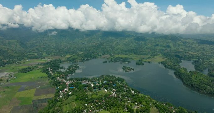 Aerial survey of body of water surrounded by agricultural land. Lake Sebu and rice fields. Mindanao, Philippines. Travel destinations.