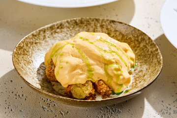 Baby potatoes topped with cheese espuma, bright lighting, overhead modern presentation
