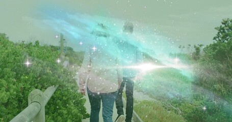 travel ad showing mature couple walking coast spurring colorful mist drifting around dogs - Powered by Adobe