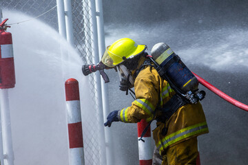 Firefighters in Action Spraying Water to Stop the Fire