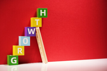 Growth word on toy blocks staircase.
