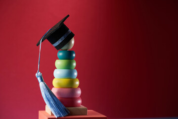 multi color toddler stacking toy with small mortarboard