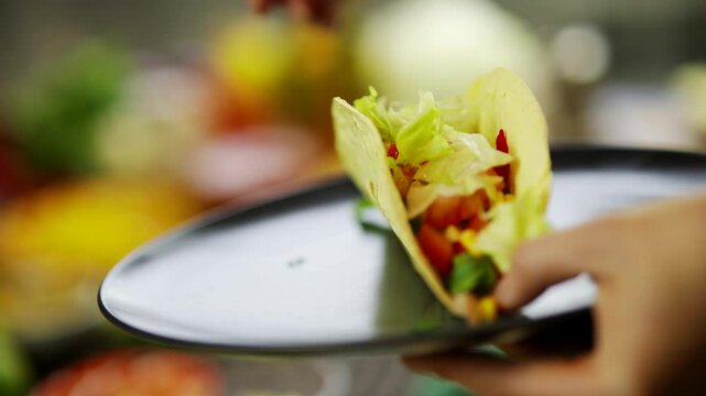 Preparing Mexican Tacos. Adding Fresh Lettuce In Tortilla Shell. Fast Food Cuisine 