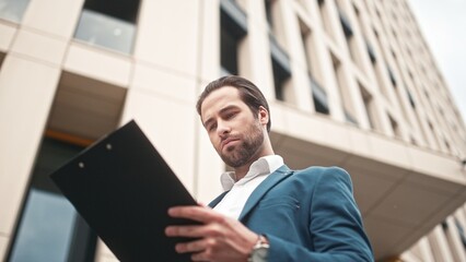 Successful busy businessman wearing suit reading plan and checking time. Handsome beautiful...
